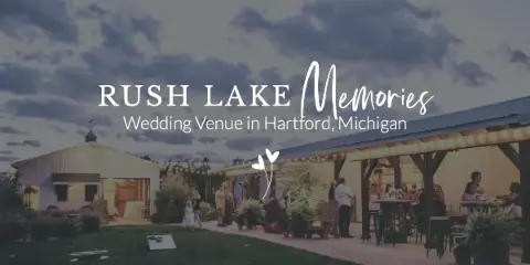Exterior view of a country-chic wedding venue featuring a large pole barn and an outdoor patio area with guests dining at dusk.