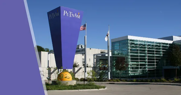 Exterior view of the Putnam Museum and Science Center building featuring a tall purple tower and glass entrance.