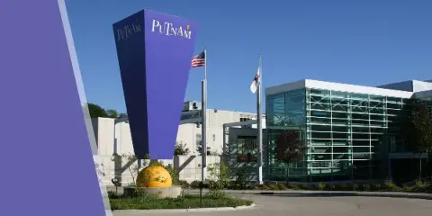 Exterior view of the Putnam Museum and Science Center building featuring a tall purple tower and glass entrance.