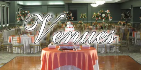 A banquet hall set up for a wedding with round tables, floral centerpieces, and a wedding cake.