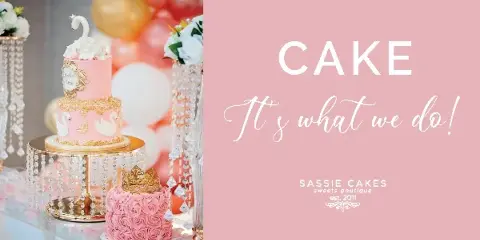 A pink two-tier buttercream wedding cake with white swan toppers and gold accents displayed on a crystal stand next to a smaller pink rose cake with a gold crown.