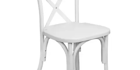 A white wooden cross-back chair on a white background