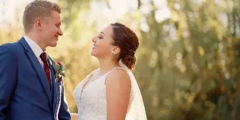 A bride and groom looking at each other during a wedding ceremony.