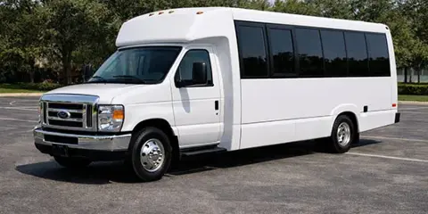 White Ford E-Series shuttle bus parked in a lot
