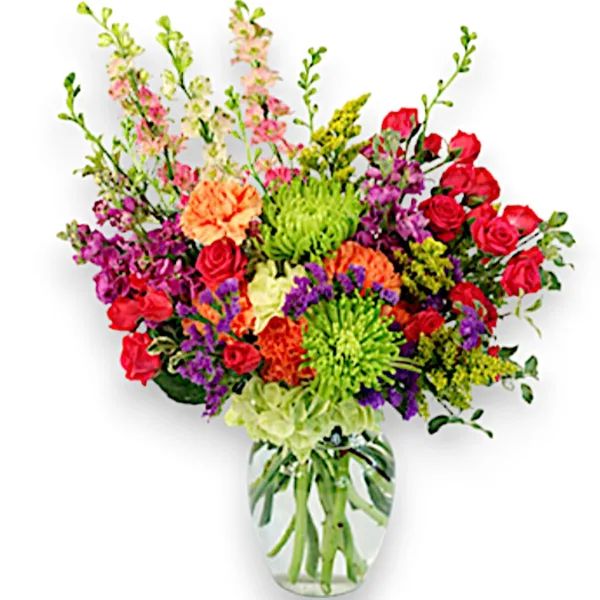 A colorful mixed bouquet of fresh flowers, including roses and chrysanthemums, arranged in a clear glass vase.