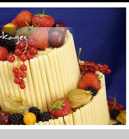 A tiered catering display featuring fresh strawberries, grapes, and blackberries arranged on a base of vertical pastry sticks.
