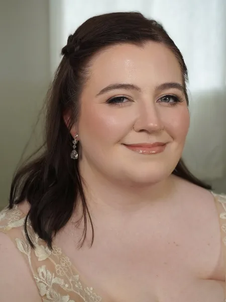 Portrait of a woman with professional bridal makeup and an elegant updo hairstyle