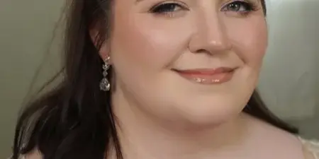 Portrait of a woman with professional bridal makeup and an elegant updo hairstyle