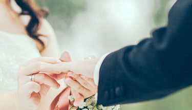 Close-up of a couple's hands during a wedding ring exchange