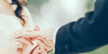 Close-up of a couple's hands during a wedding ring exchange
