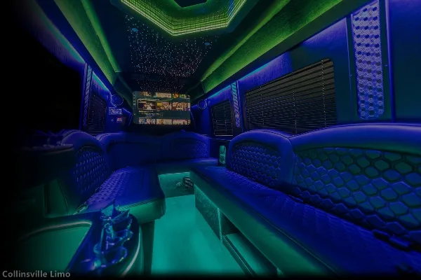 Interior view of a party bus with blue and green ambient lighting, quilted leather seating, and a mounted television screen.