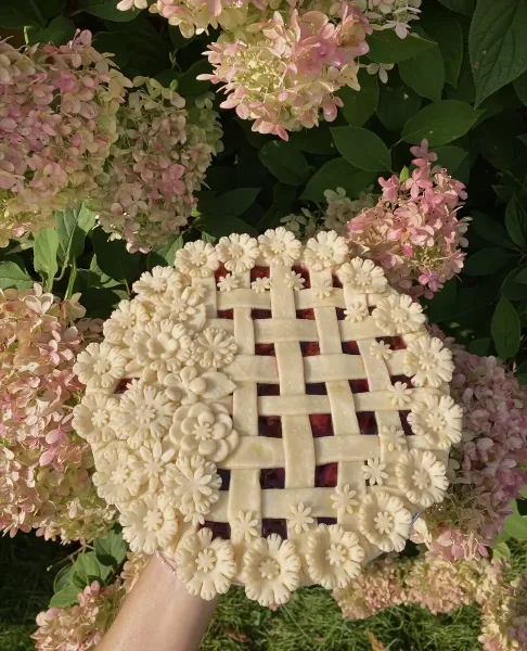 A berry pie with a lattice top and hand-cut pie-crust florals, baked by Birdie's Baking Co. in Columbia City, Indiana