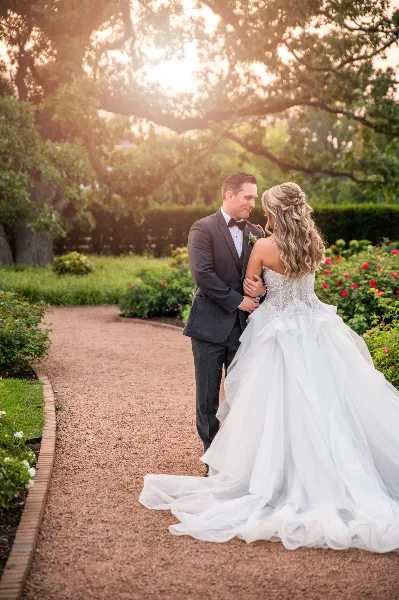 Bride and groom portrait in a garden at sunset
