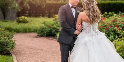 Bride and groom portrait in a garden at sunset