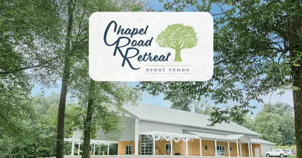 Exterior view of the Chapel Road Retreat event venue building featuring a covered patio and wooden facade.