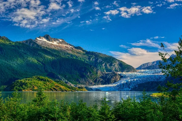 A scenic view of the Mendenhall Glacier and surrounding mountains in Alaska.