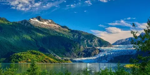 A scenic view of the Mendenhall Glacier and surrounding mountains in Alaska.