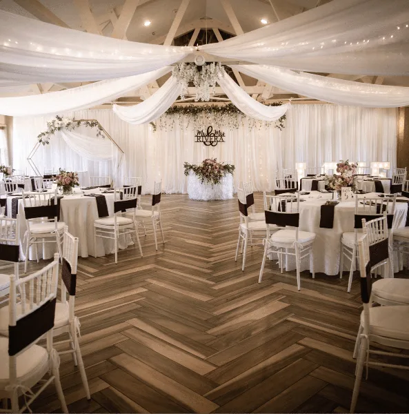 Ivory drapery and hanging florals over dancefloor