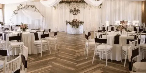 Ivory drapery and hanging florals over dancefloor