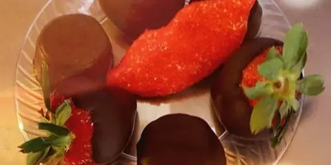 A plate of chocolate-dipped strawberries and chocolate truffles