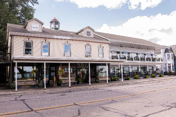 Exterior view of the Marine City Fish Company restaurant featuring a two-story building with a covered patio and riverfront setting.