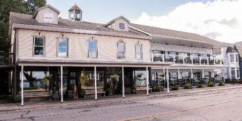 Exterior view of the Marine City Fish Company restaurant featuring a two-story building with a covered patio and riverfront setting.