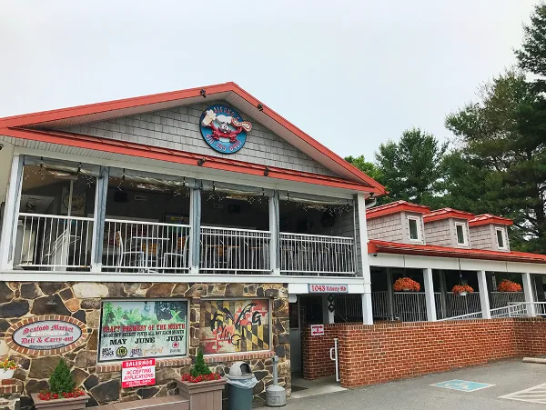 Exterior view of Salerno's Restaurant & Catering building with stone facade, red roof, and signage