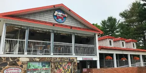 Exterior view of Salerno's Restaurant & Catering building with stone facade, red roof, and signage