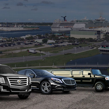 A fleet of luxury vehicles, including a black Cadillac SUV, a black Mercedes-Benz sedan, and a black stretch limousine, parked in front of a cruise ship port.