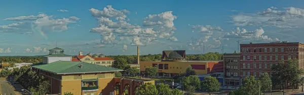 Exterior view of the Macon-Bibb County government complex and courthouse buildings under a blue sky.