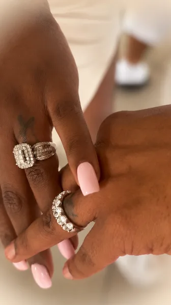Close-up of two hands wearing diamond wedding rings