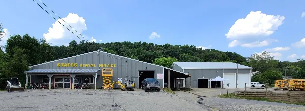 Exterior view of the States Rental Service building with various construction and landscaping equipment parked in the lot.