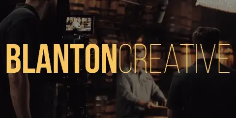A behind-the-scenes shot of a video production crew filming a subject with a professional camera and boom microphone.