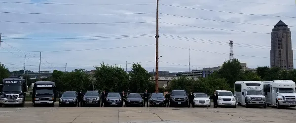 A lineup of Royal Rides chauffeured vehicles including limo buses, SUVs, and sedans with drivers standing in front.