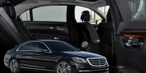 Black luxury sedan with open doors showing leather interior and sunroof