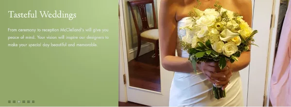 A bride in a white dress holding a bouquet of white roses and calla lilies.