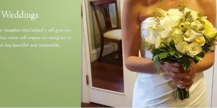 A bride in a white dress holding a bouquet of white roses and calla lilies.