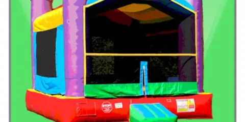 A colorful inflatable bounce house with castle turrets and a slide.