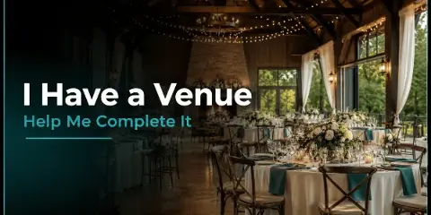 A rustic event venue interior featuring round tables with white linens, wooden chairs, and floral centerpieces under string lights.