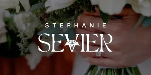 Close-up of a hand holding a white wedding bouquet with an engagement ring visible, overlaid with the text 'STEPHANIE SEVIER'.
