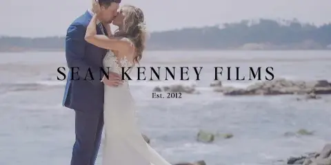 A bride and groom sharing a kiss on a beach, with the text 'SEAN KENNEY FILMS Est. 2012' overlaid.