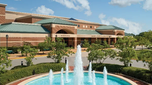 Exterior view of the St. Charles Convention Center building featuring a fountain and landscaped grounds.