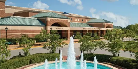 Exterior view of the St. Charles Convention Center building featuring a fountain and landscaped grounds.
