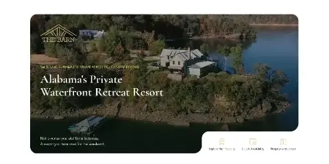 Aerial view of a private waterfront resort featuring multiple lakefront buildings, a dock, and surrounding wooded property on a large lake.