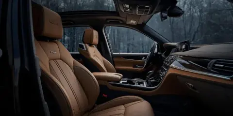 Interior view of a luxury SUV with tan leather seats and a modern dashboard.