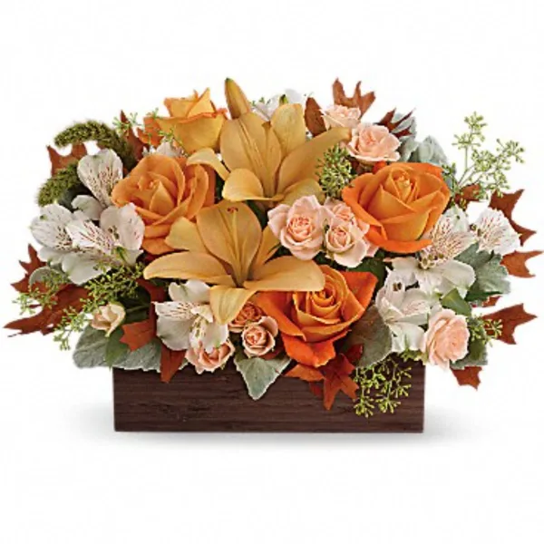 A floral arrangement featuring orange roses, yellow lilies, and white alstroemeria in a rectangular wooden box.