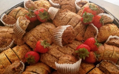 A large platter of baked pastries garnished with fresh strawberries.