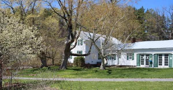 Exterior view of the Landis Arboretum building with green shutters and surrounding trees