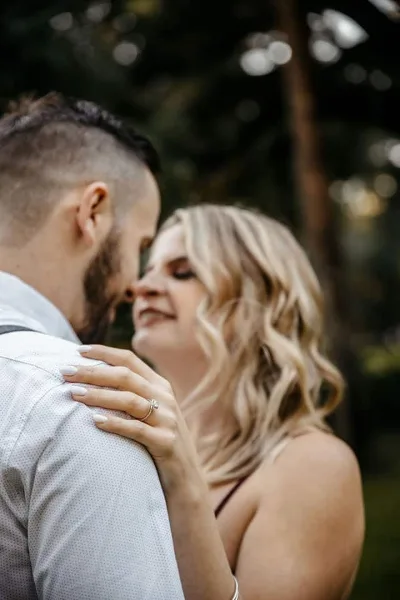 A close-up wedding portrait of a couple embracing, with the woman's hand resting on the man's shoulder, captured by a Georgia wedding photographer.