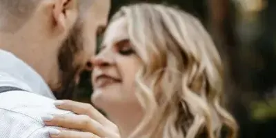 A close-up wedding portrait of a couple embracing, with the woman's hand resting on the man's shoulder, captured by a Georgia wedding photographer.